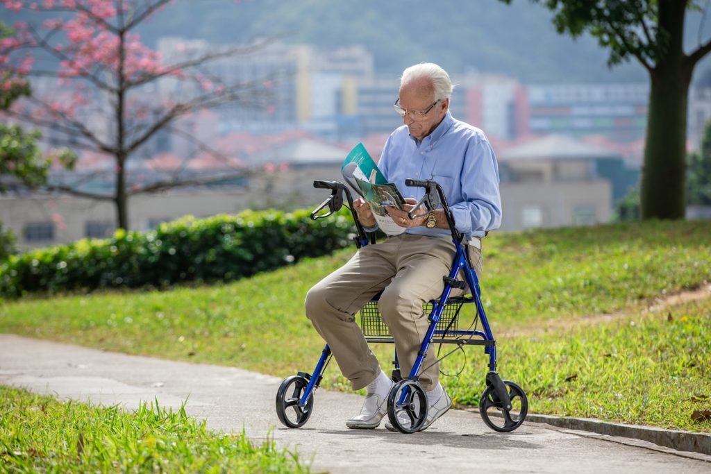 Senior adult using a rollator outdoors