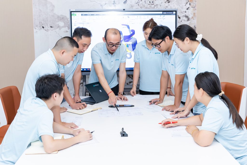 Yumin team reviewing mobility product information